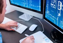 A picture of a person, working on the computer.