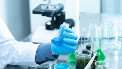 A person holding a laboratory flask.